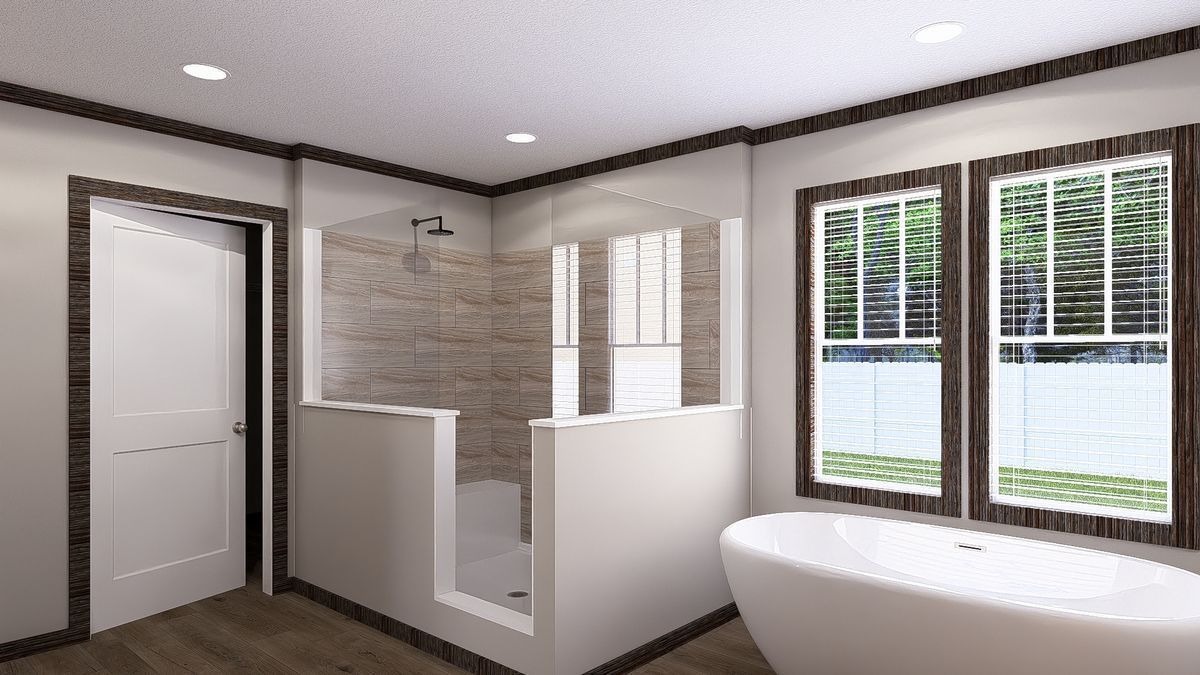 A bathroom with a tub, a shower, and two windows.
