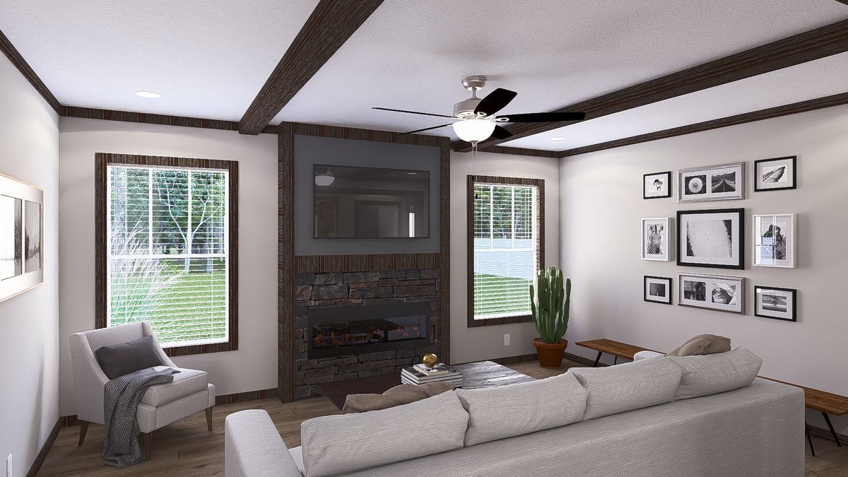 A living room with a couch, chair, fireplace, and television.