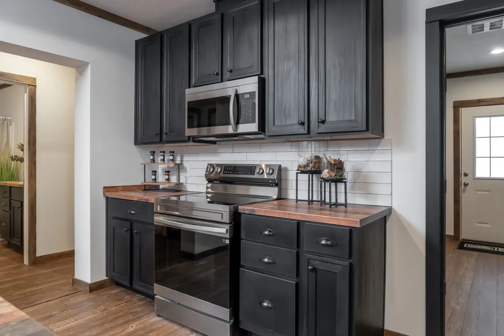 Black cabinets and stainless steel appliances.