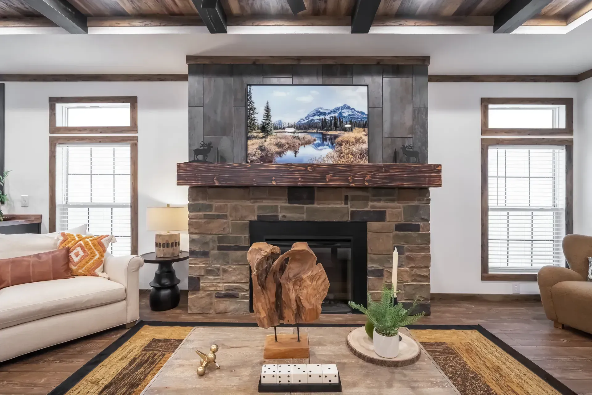 A living room with a fireplace, a couch, a chair, and a television.