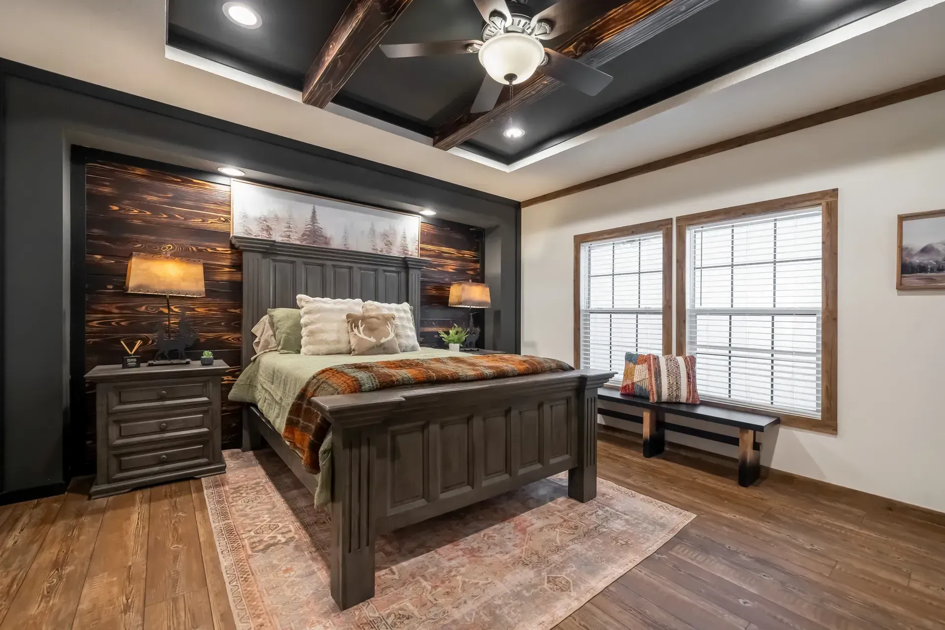 A bedroom with a bed, nightstands, and a ceiling fan.
