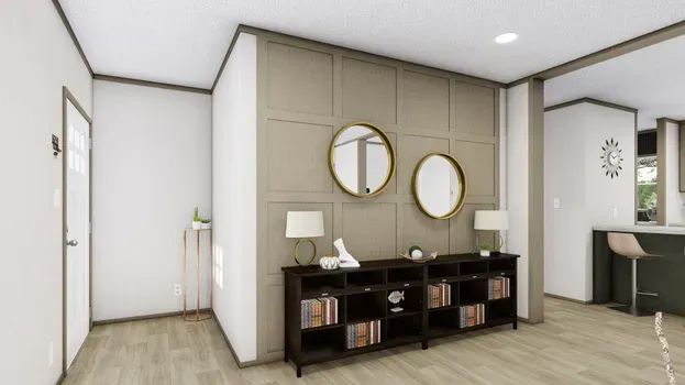 Living room with dark wood console, round mirrors, and neutral wall paneling.
