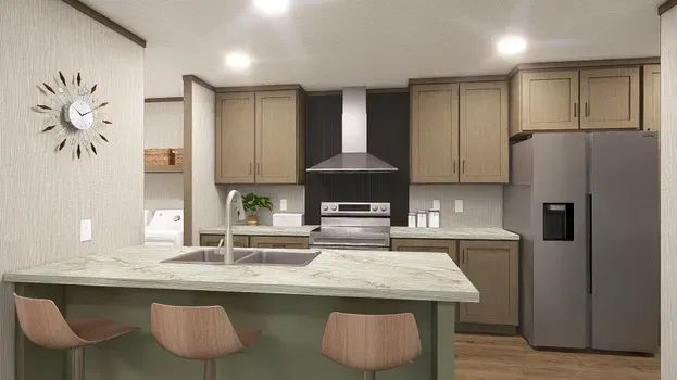 Kitchen with green island, beige cabinets, gray refrigerator, and three barstools.