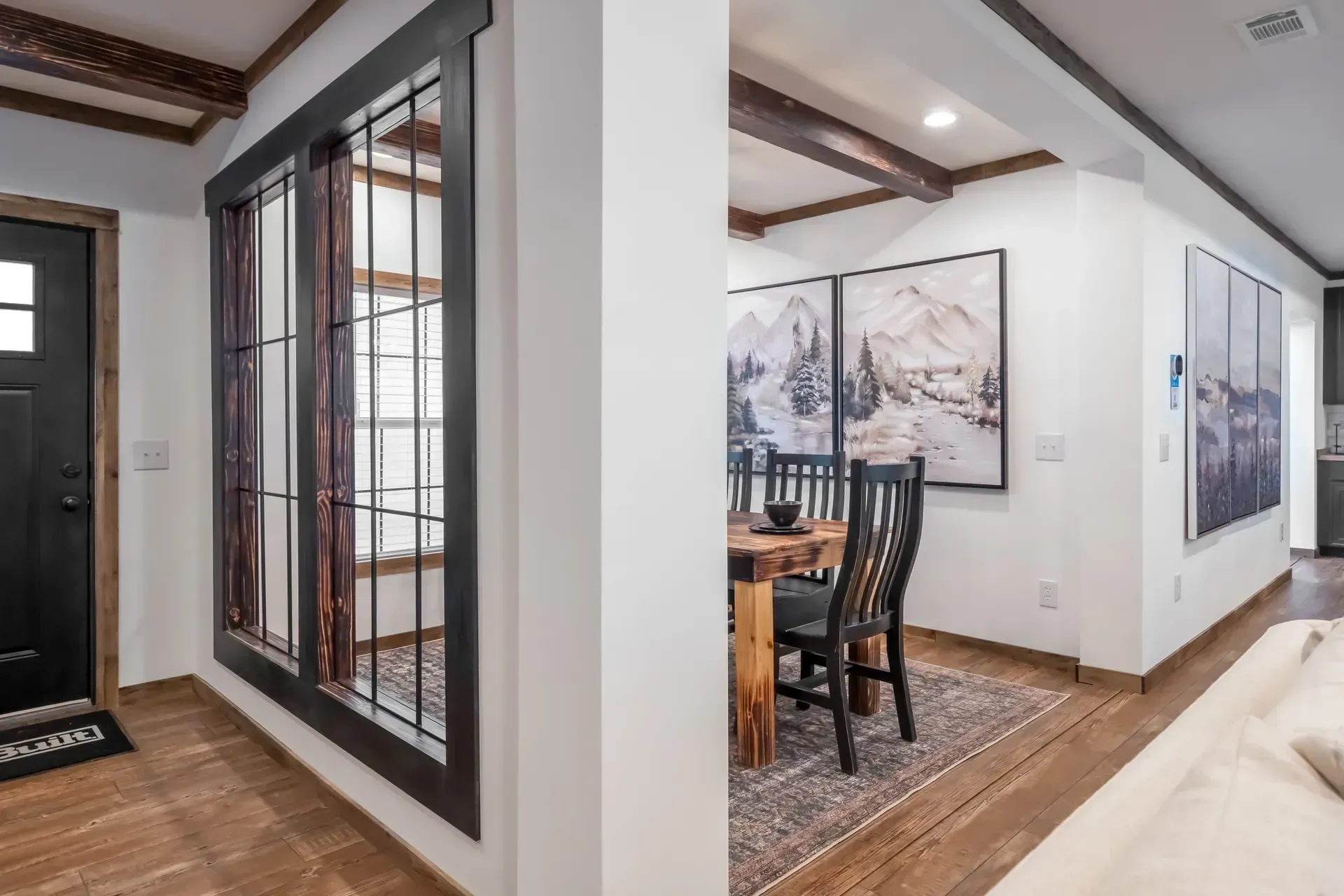 A living room with a table and chairs and a dining room with a table and chairs.