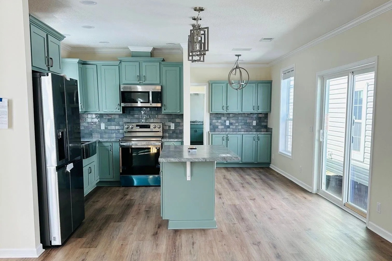 A kitchen with blue cabinets and stainless steel appliances