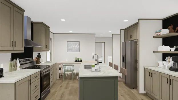 Modern kitchen with green island, light wood floors, and neutral cabinets.
