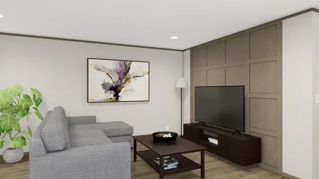 Modern living room with grey sectional, artwork, TV, and dark wood coffee table.