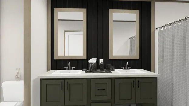 Bathroom with dual sinks, green cabinets, dark wood wall, beige-framed mirrors, and patterned shower curtain.