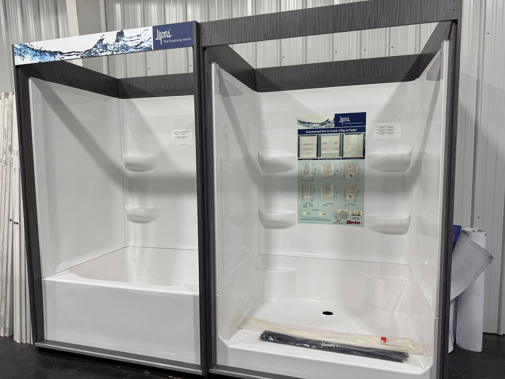 A shower stall with two tubs and shelves in a room.