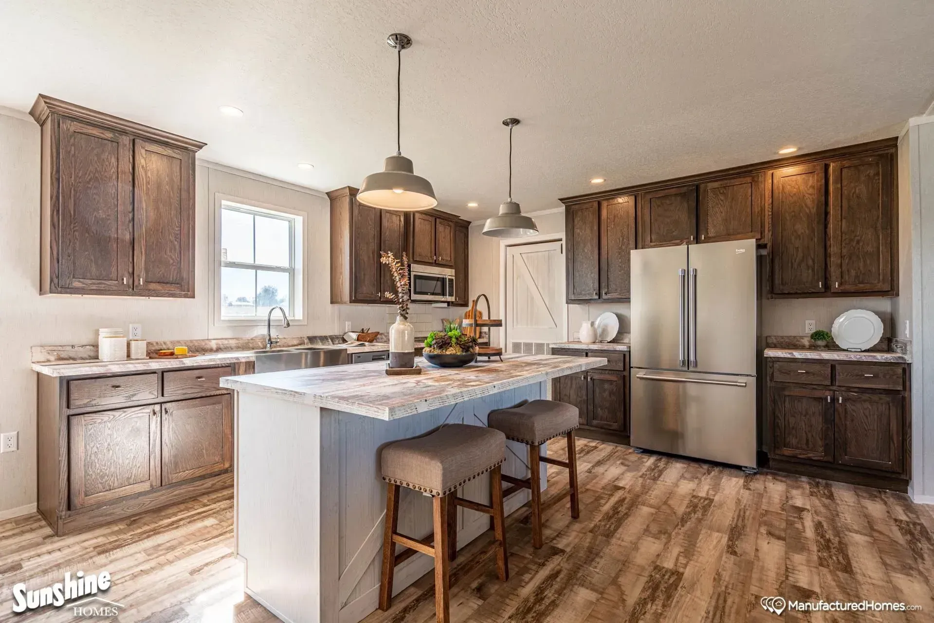 A kitchen with stainless steel appliances and wooden cabinets