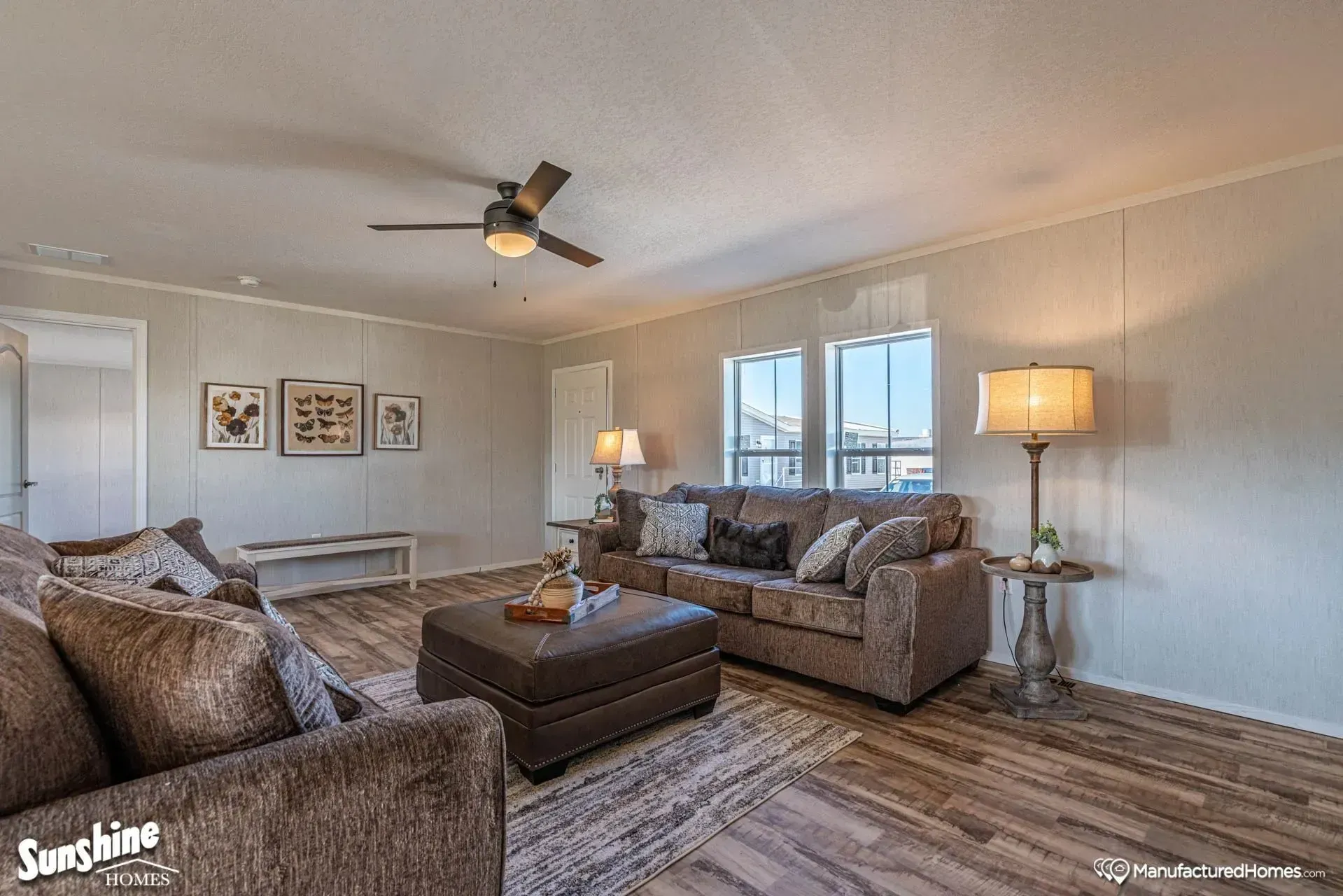 A living room filled with furniture and a ceiling fan