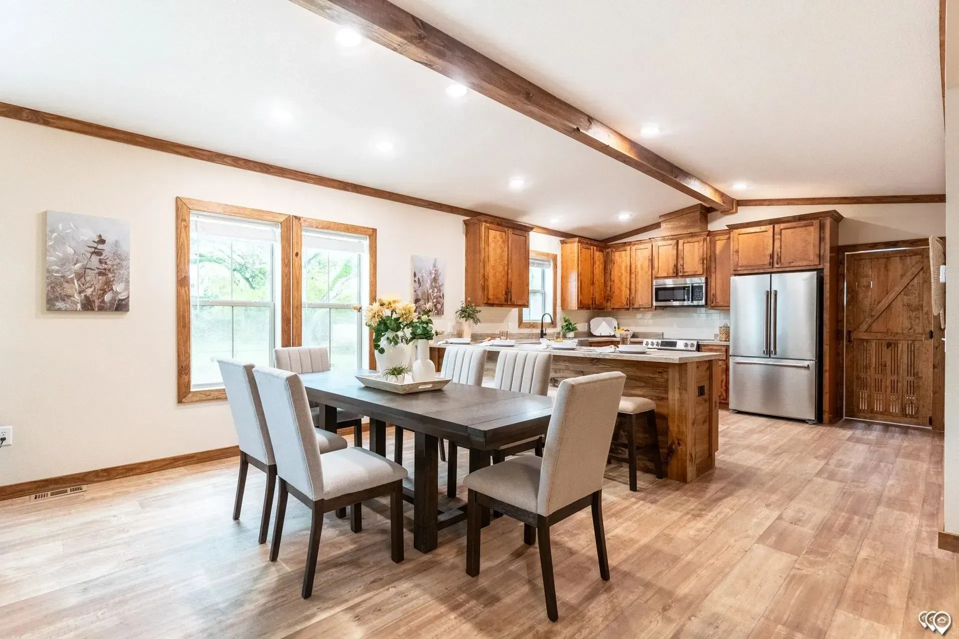 There is a dining table and chairs in the middle of the room