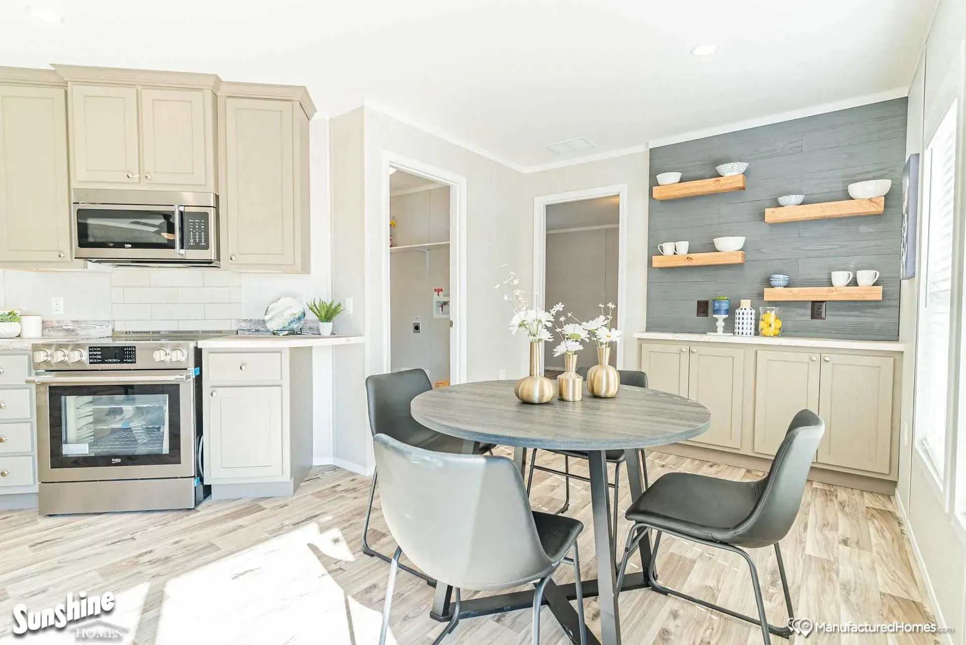 A kitchen and dining room in a mobile home with a table and chairs