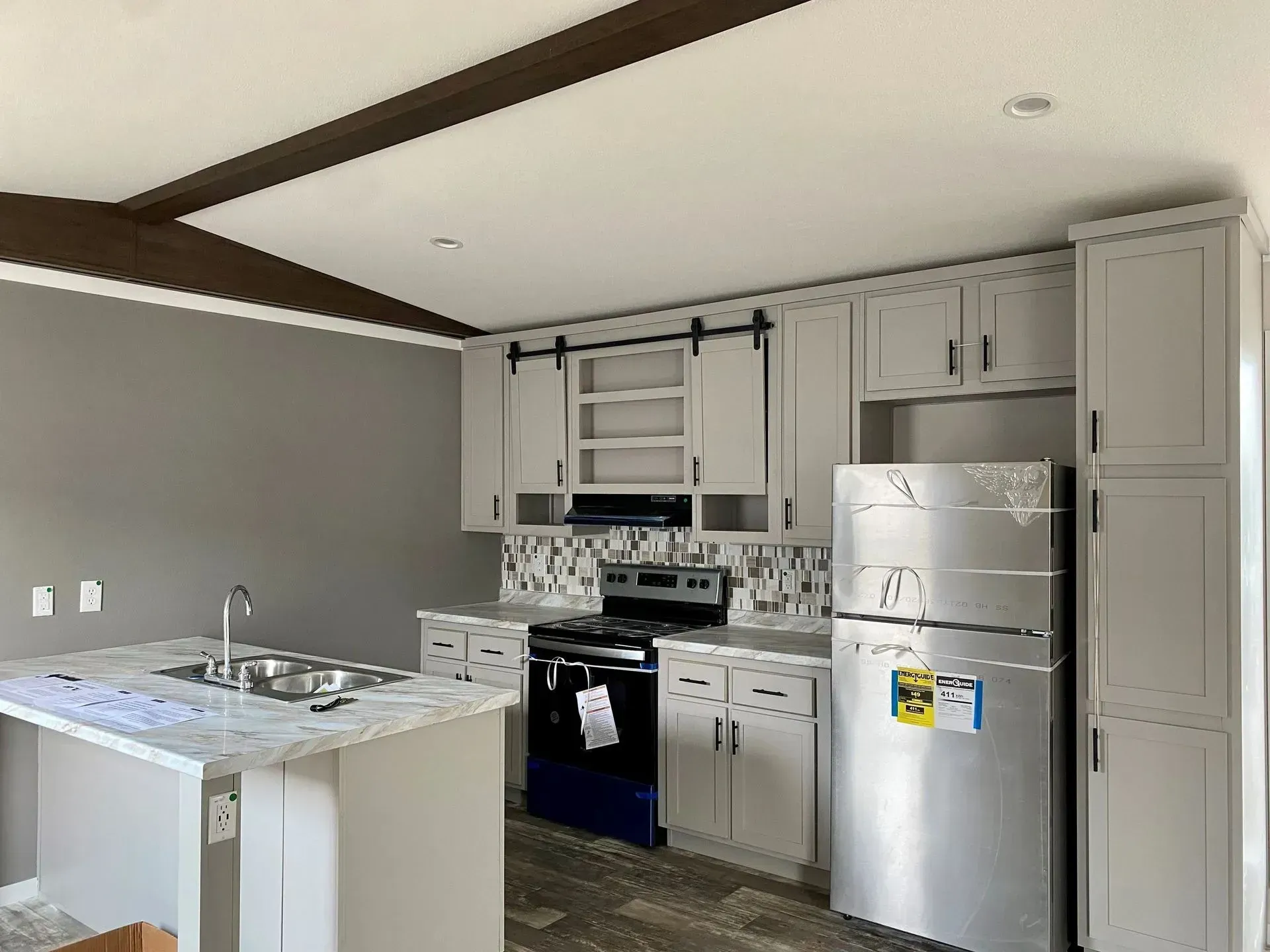 A kitchen with stainless steel appliances and white cabinets