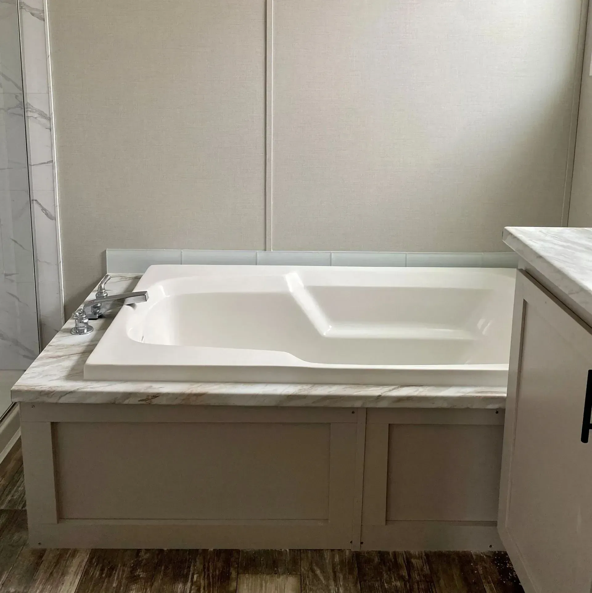 There is a bathtub in the middle of the bathroom