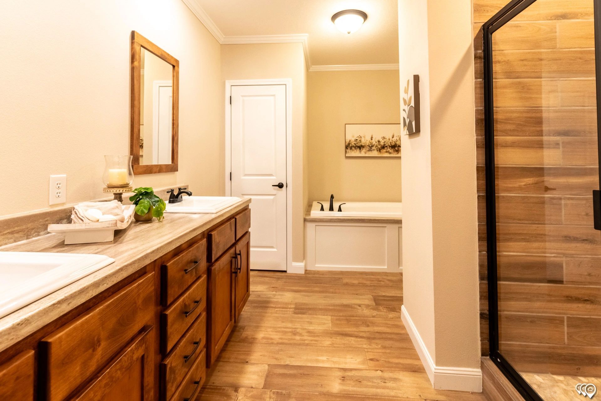 A bathroom with two sinks , a tub , and a walk in shower.