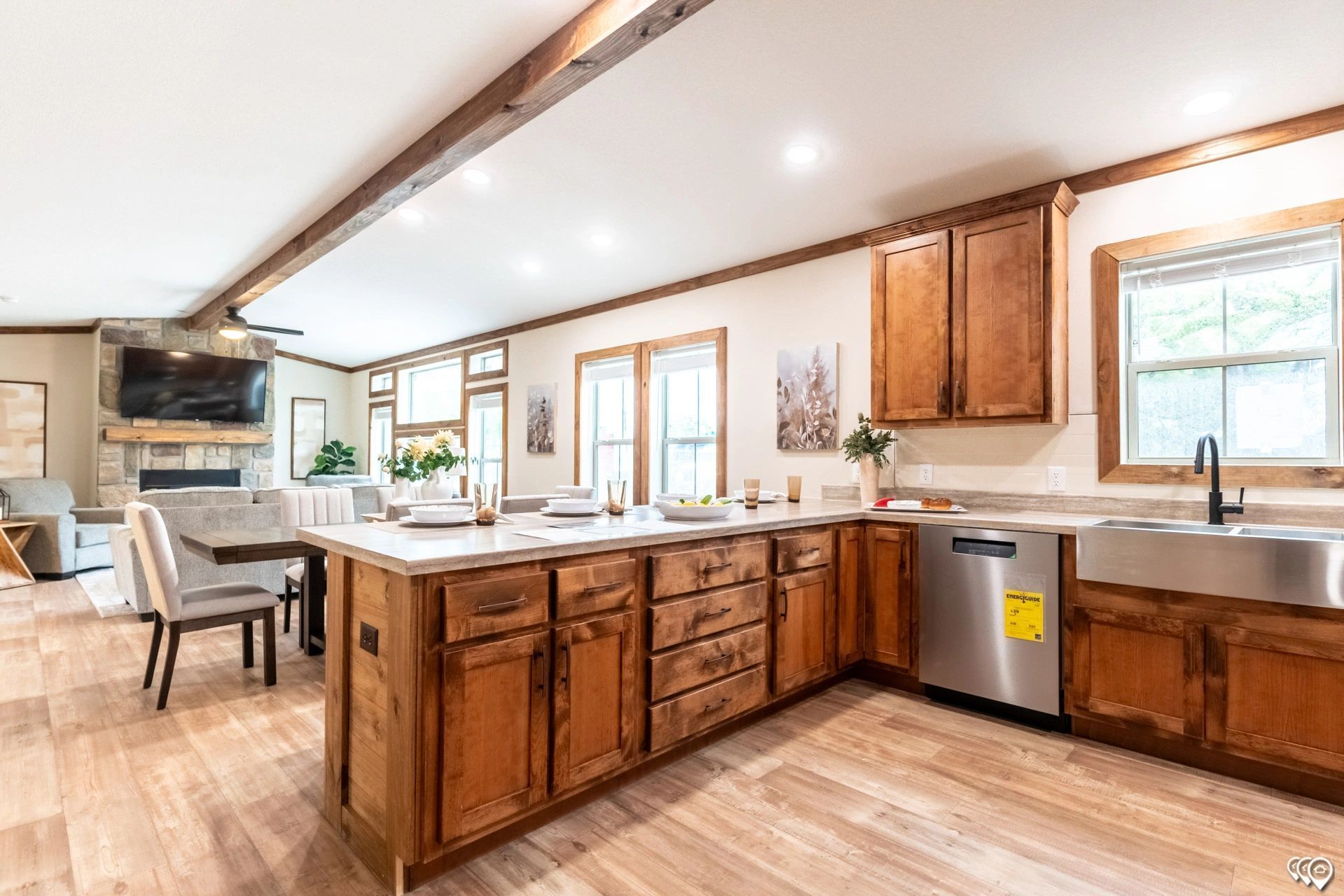 A kitchen in a house with wooden cabinets and stainless steel appliances.