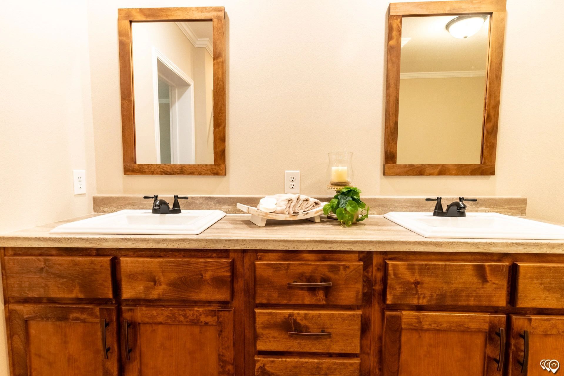 A bathroom with two sinks and two mirrors.