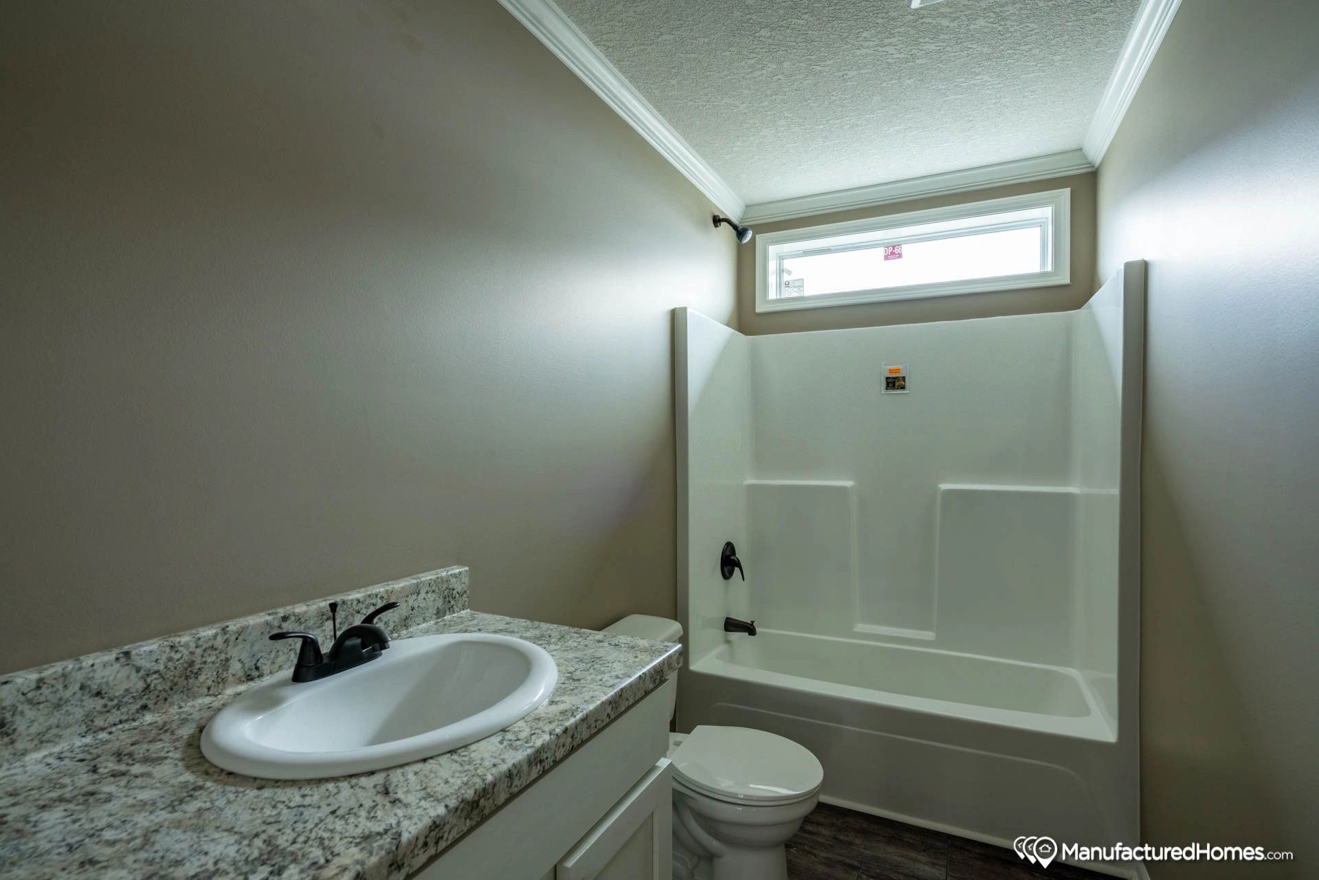 A bathroom with a sink , toilet , and bathtub.