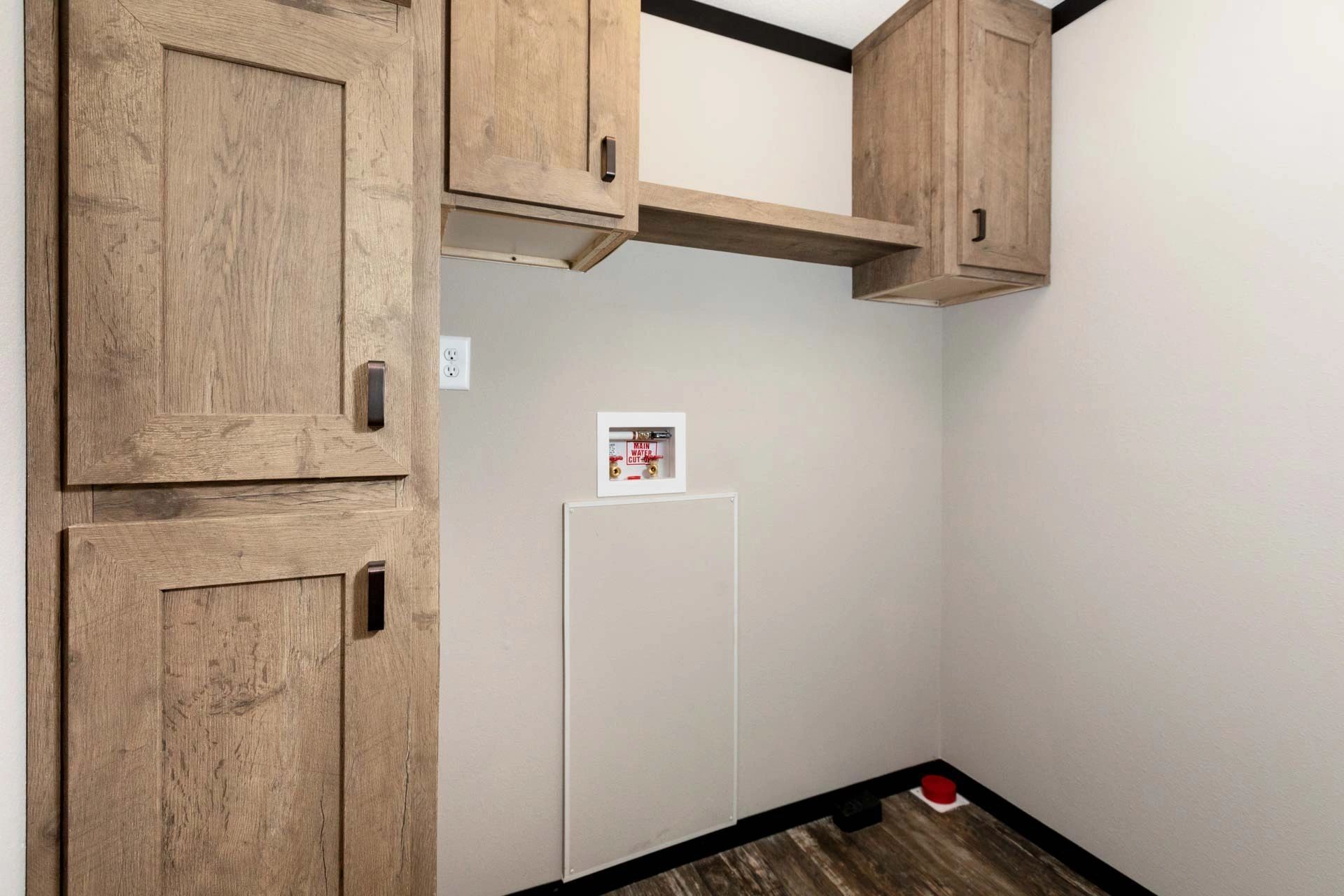 A laundry room with wooden cabinets and a washer and dryer.