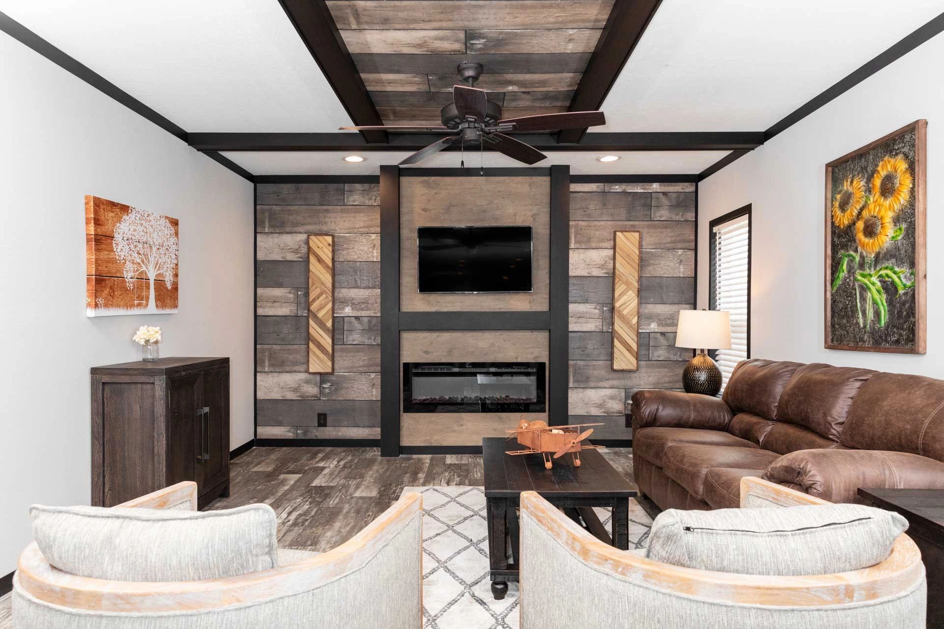 A living room with a couch , chairs , a fireplace and a flat screen tv.