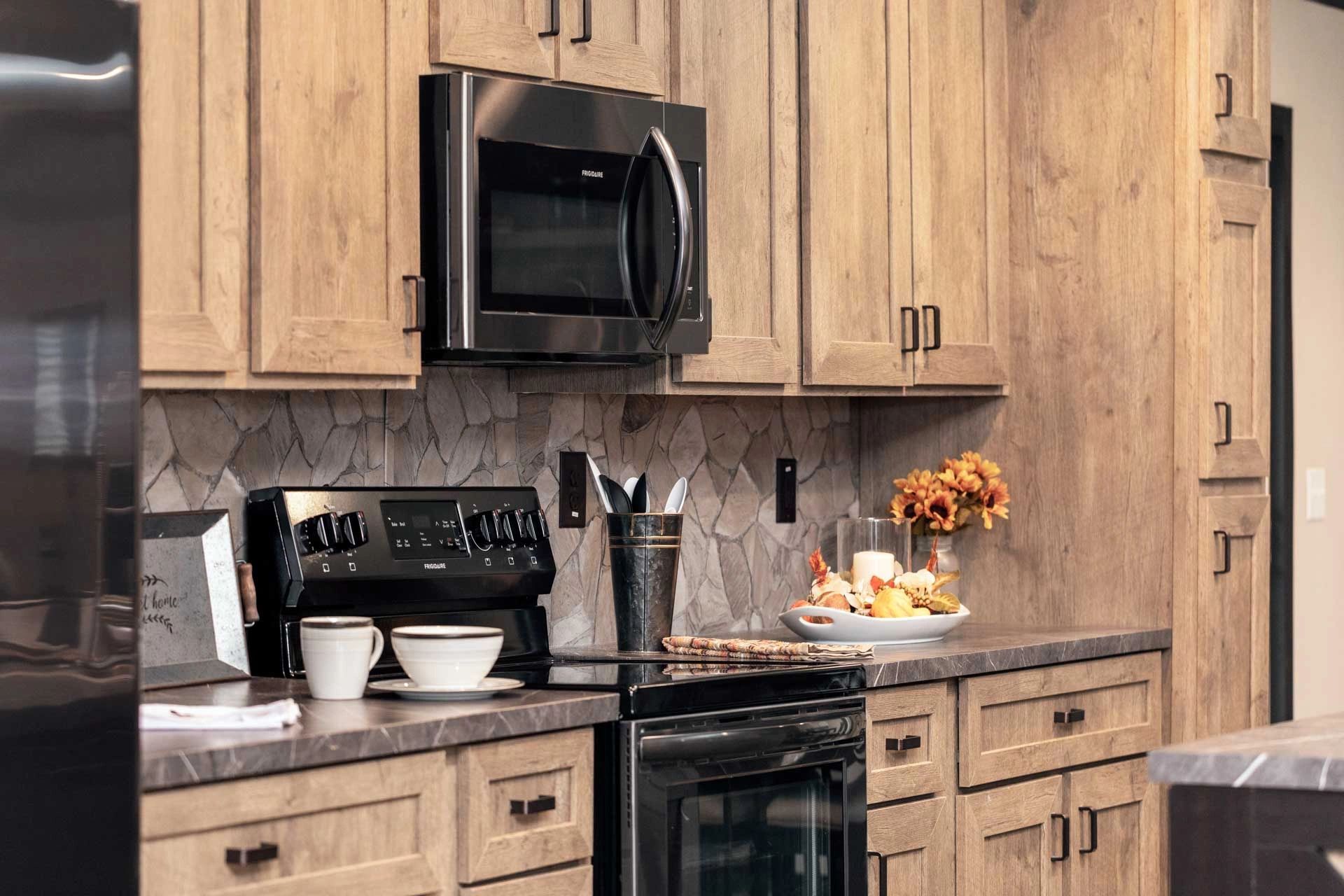 A kitchen with stainless steel appliances and wooden cabinets.