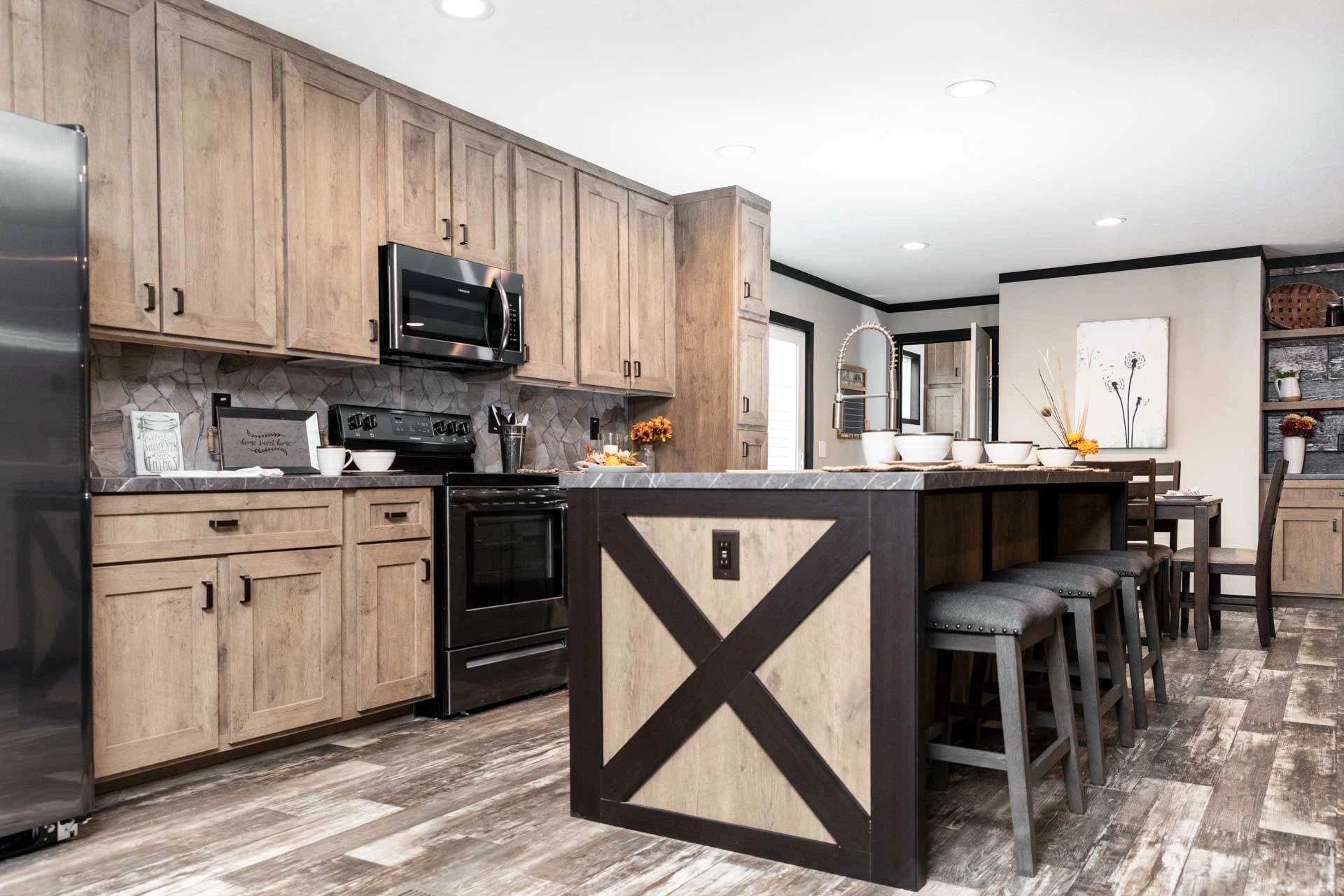 A kitchen with wooden cabinets , stainless steel appliances , and a large island.