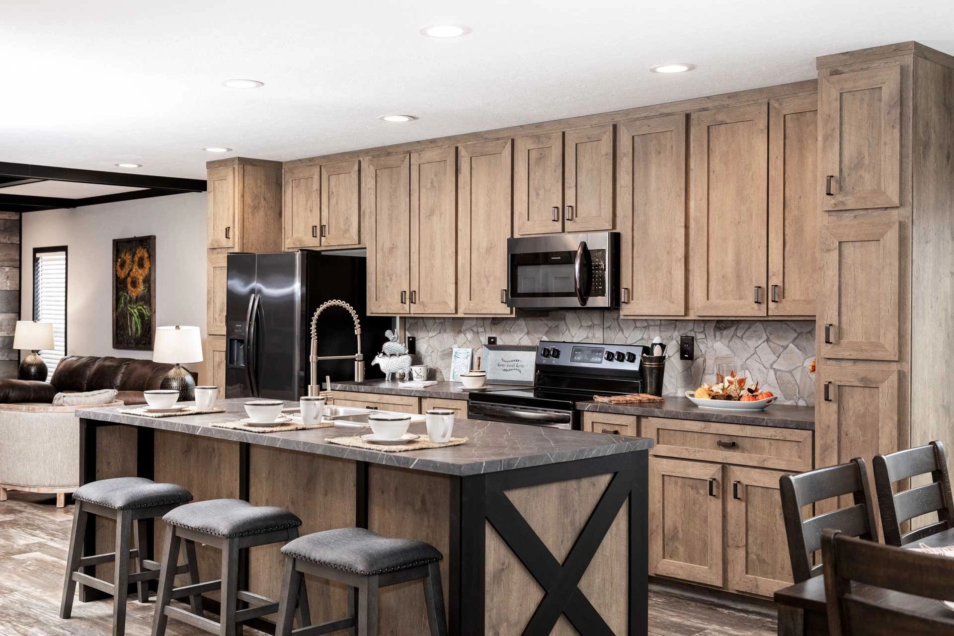 A kitchen with wooden cabinets , stainless steel appliances , and a large island.