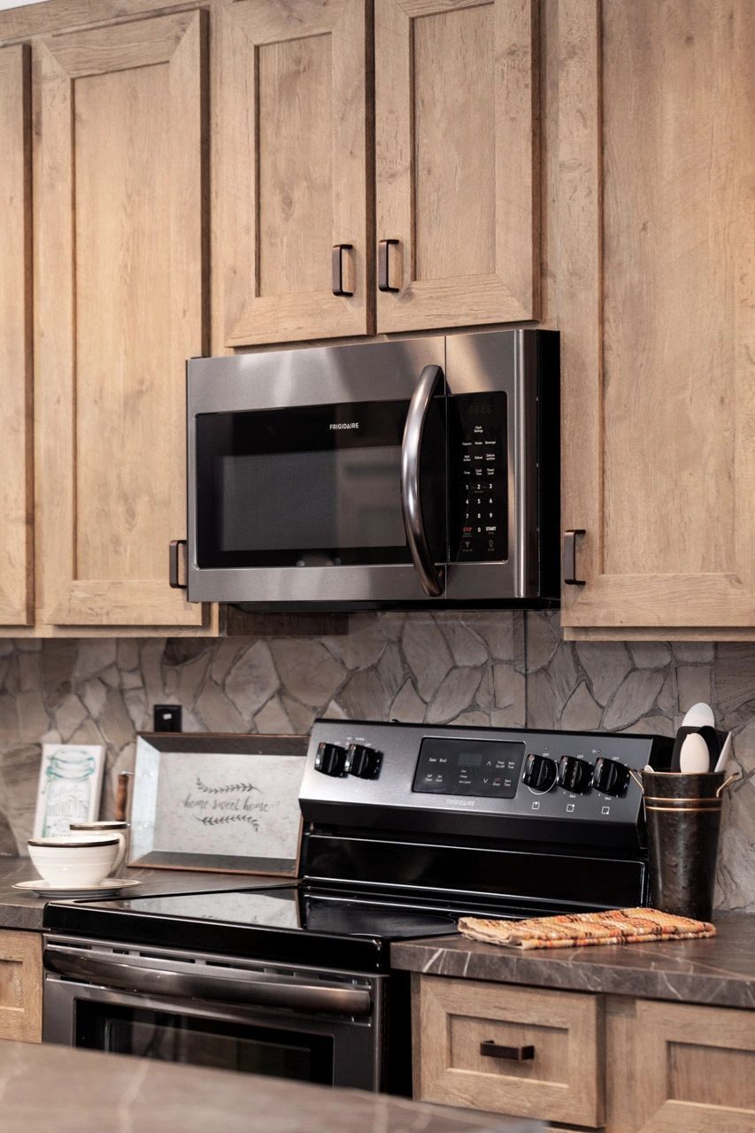 A kitchen with stainless steel appliances and wooden cabinets
