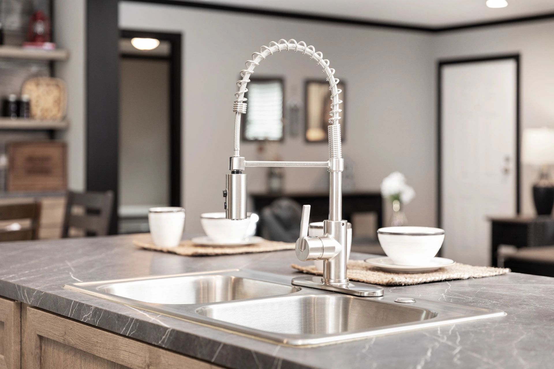A kitchen sink with a faucet and bowls on the counter.