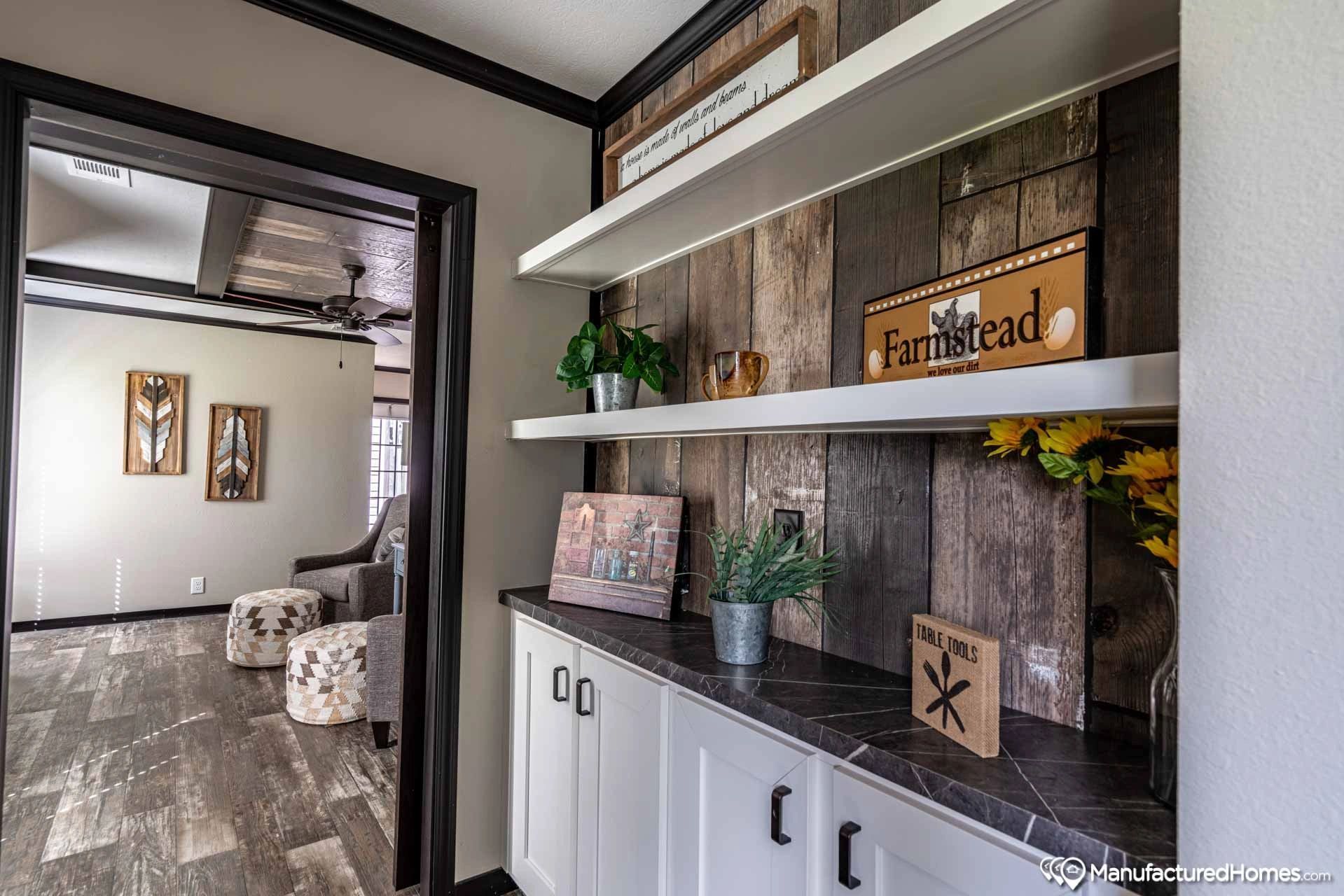 A hallway in a house with a wooden wall and shelves.