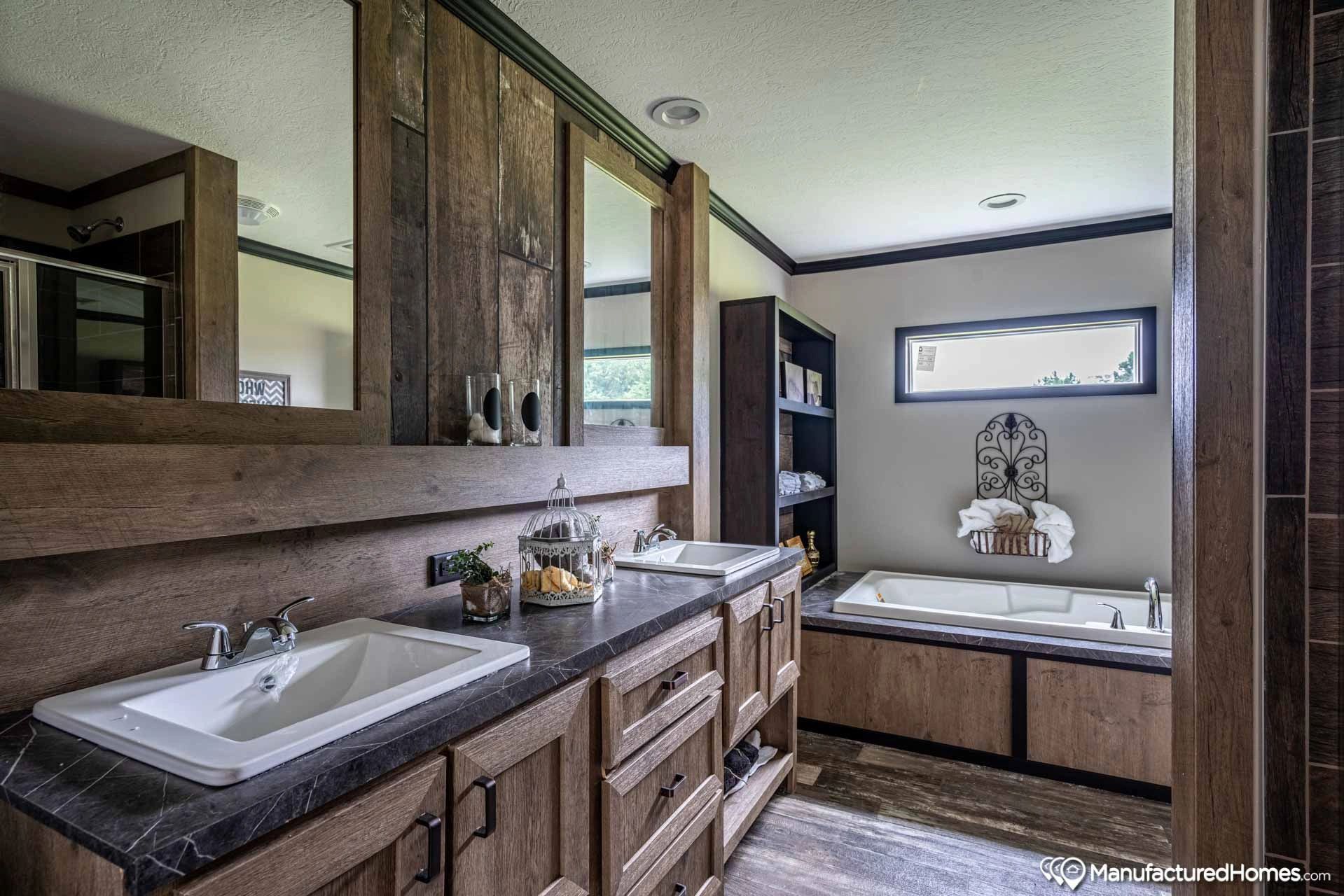 A bathroom with two sinks and a tub.
