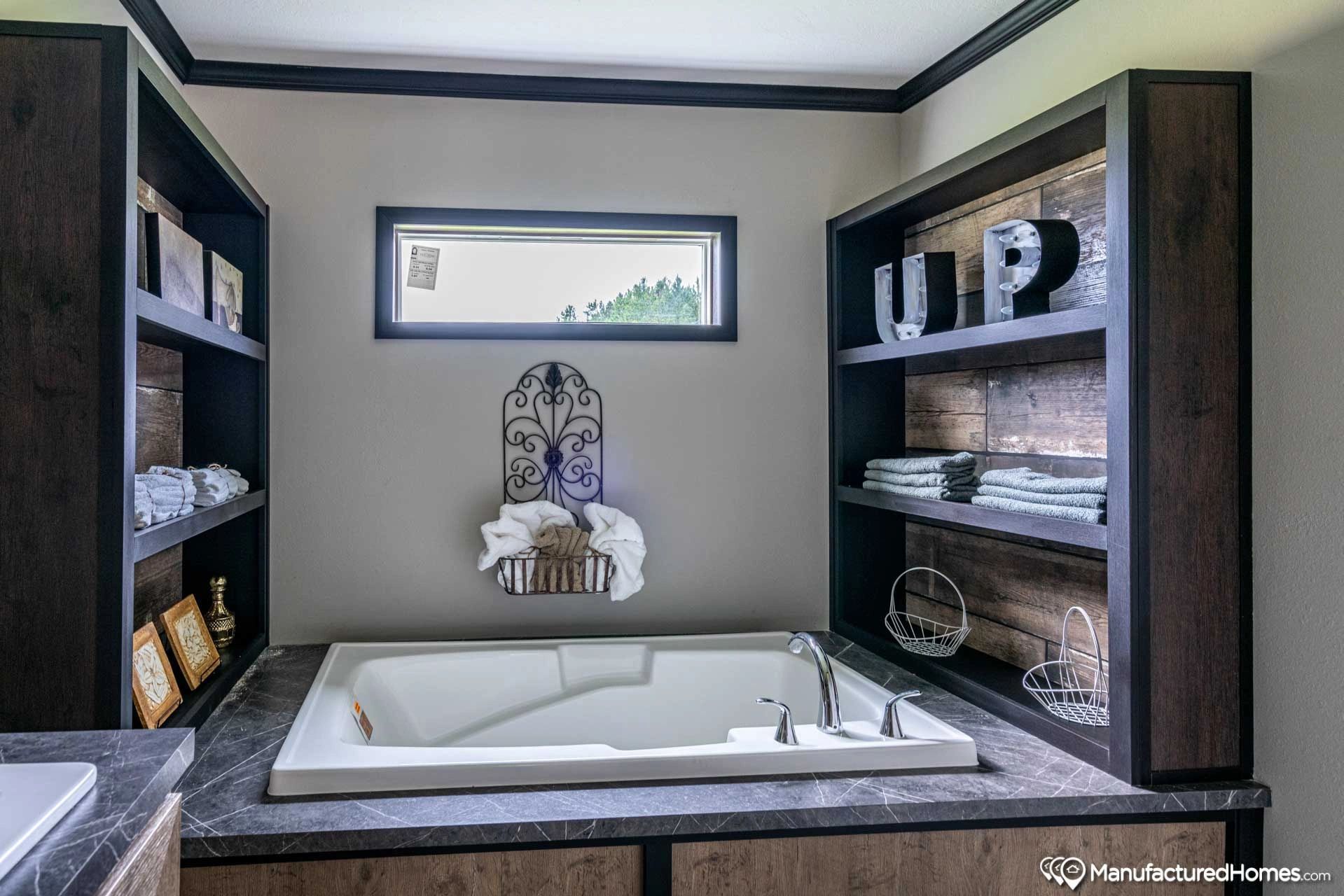 A bathroom with a jacuzzi tub and shelves.