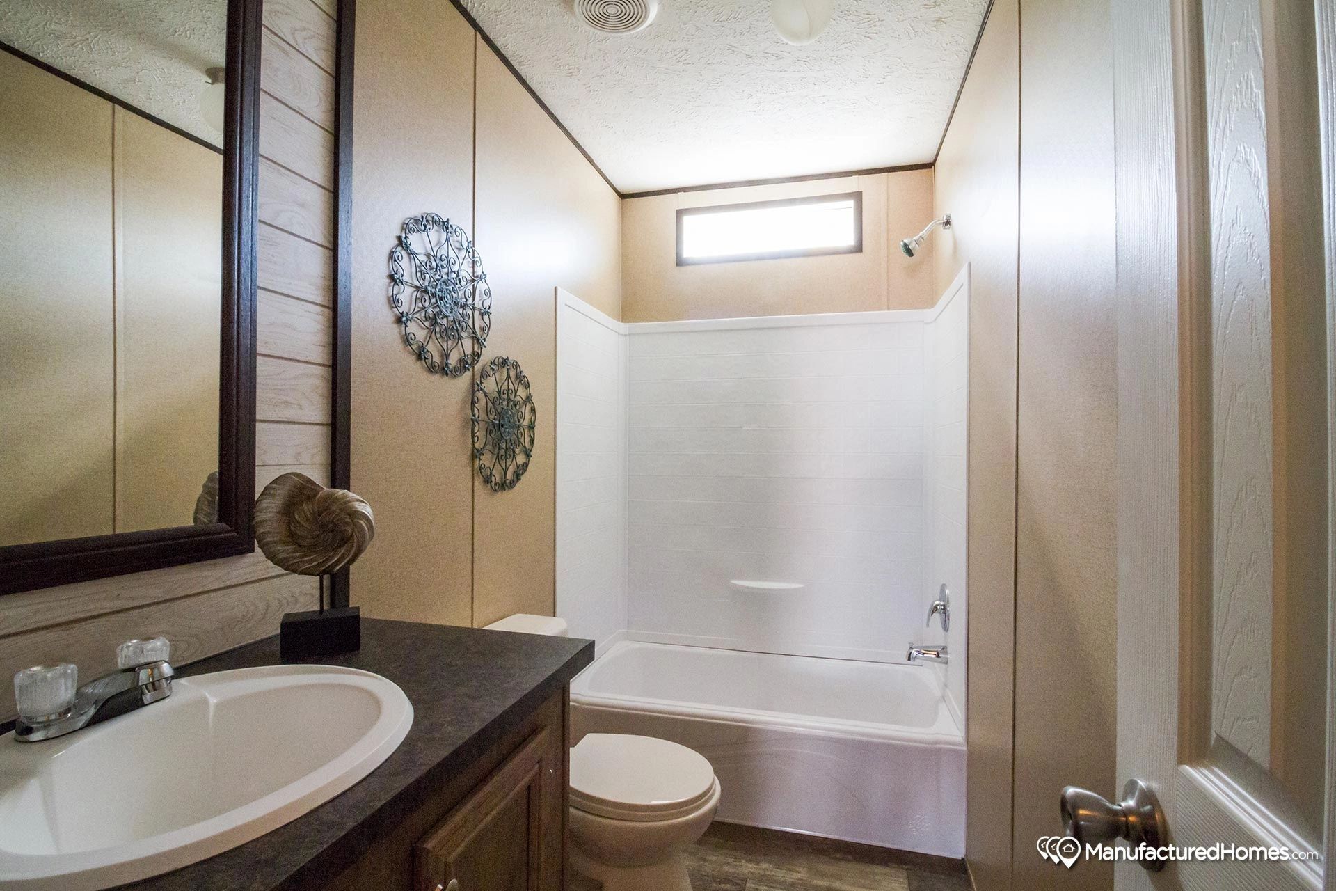 A bathroom with a sink , toilet , and bathtub.