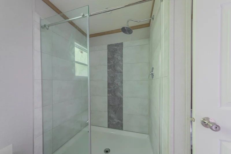 A bathroom with a walk in shower and a bathtub.