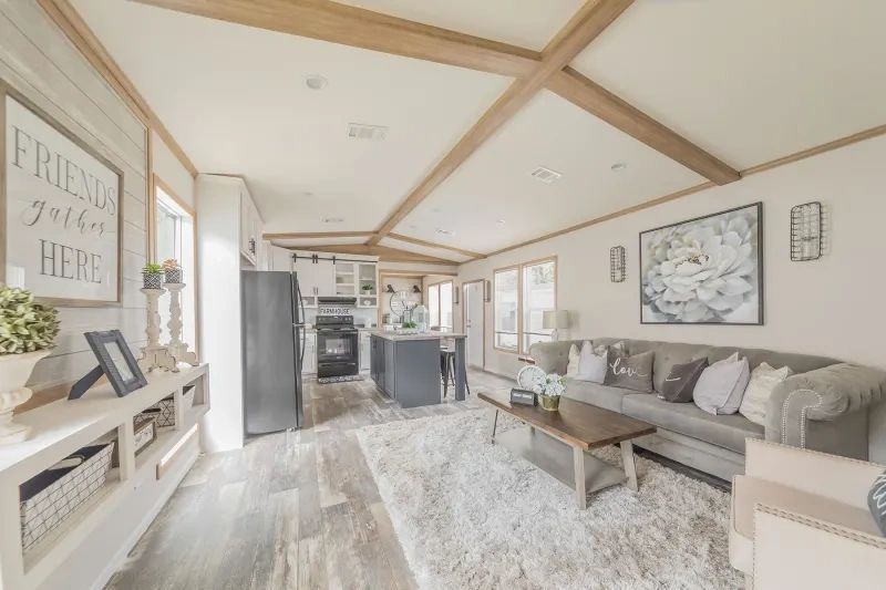 A living room in a mobile home with a couch and a coffee table.