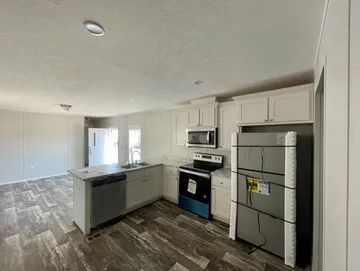A kitchen with a refrigerator , stove , microwave and dishwasher.