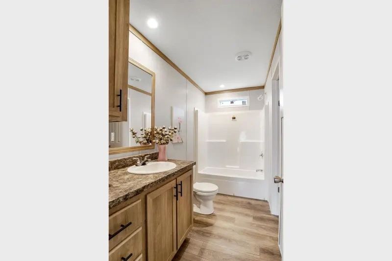A bathroom with a sink , toilet , and bathtub.