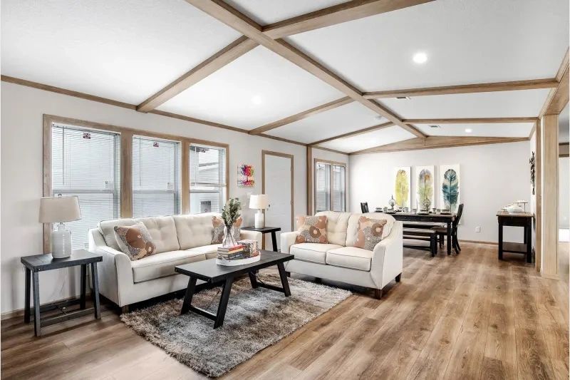 A living room with a couch , table , and rug.