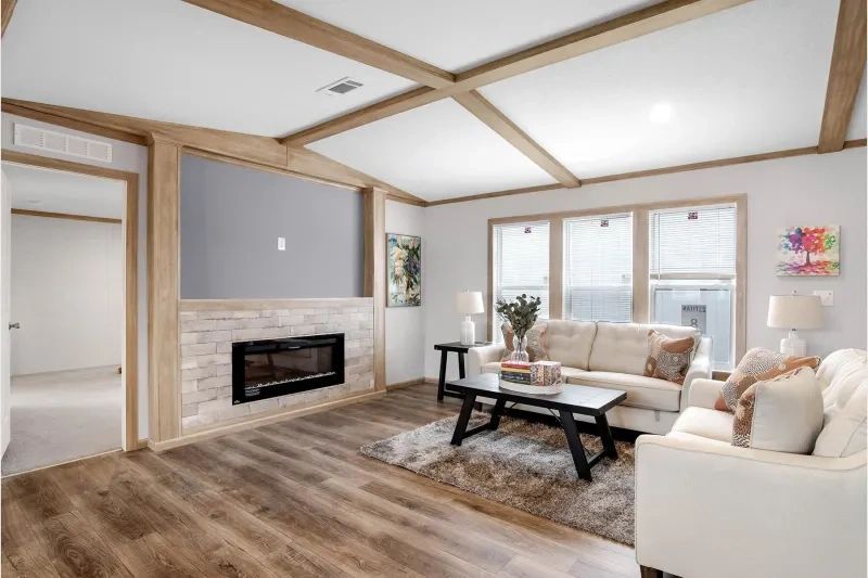A living room with a couch , coffee table and fireplace.