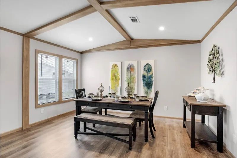 A dining room with a table and chairs and a bench.