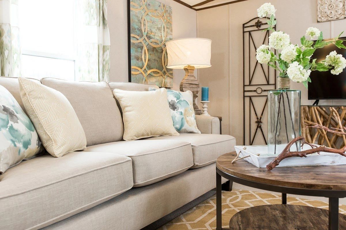 A living room with a couch , coffee table , and television.