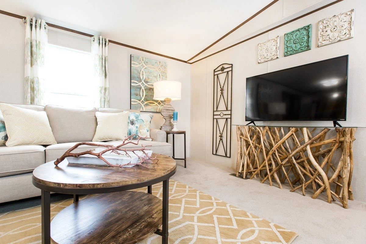 A living room with a couch , table , and television.