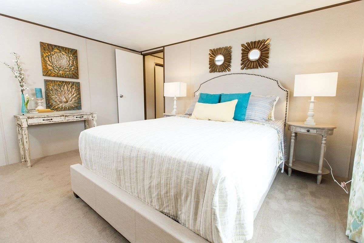 A bedroom with a king size bed and two nightstands.