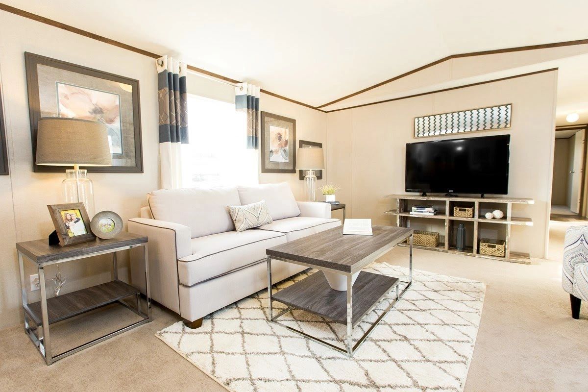 A living room with a couch , coffee table , and television.