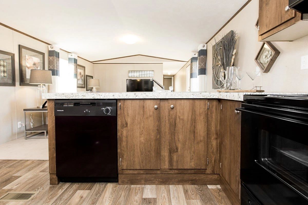 A kitchen with wooden cabinets and a black dishwasher.