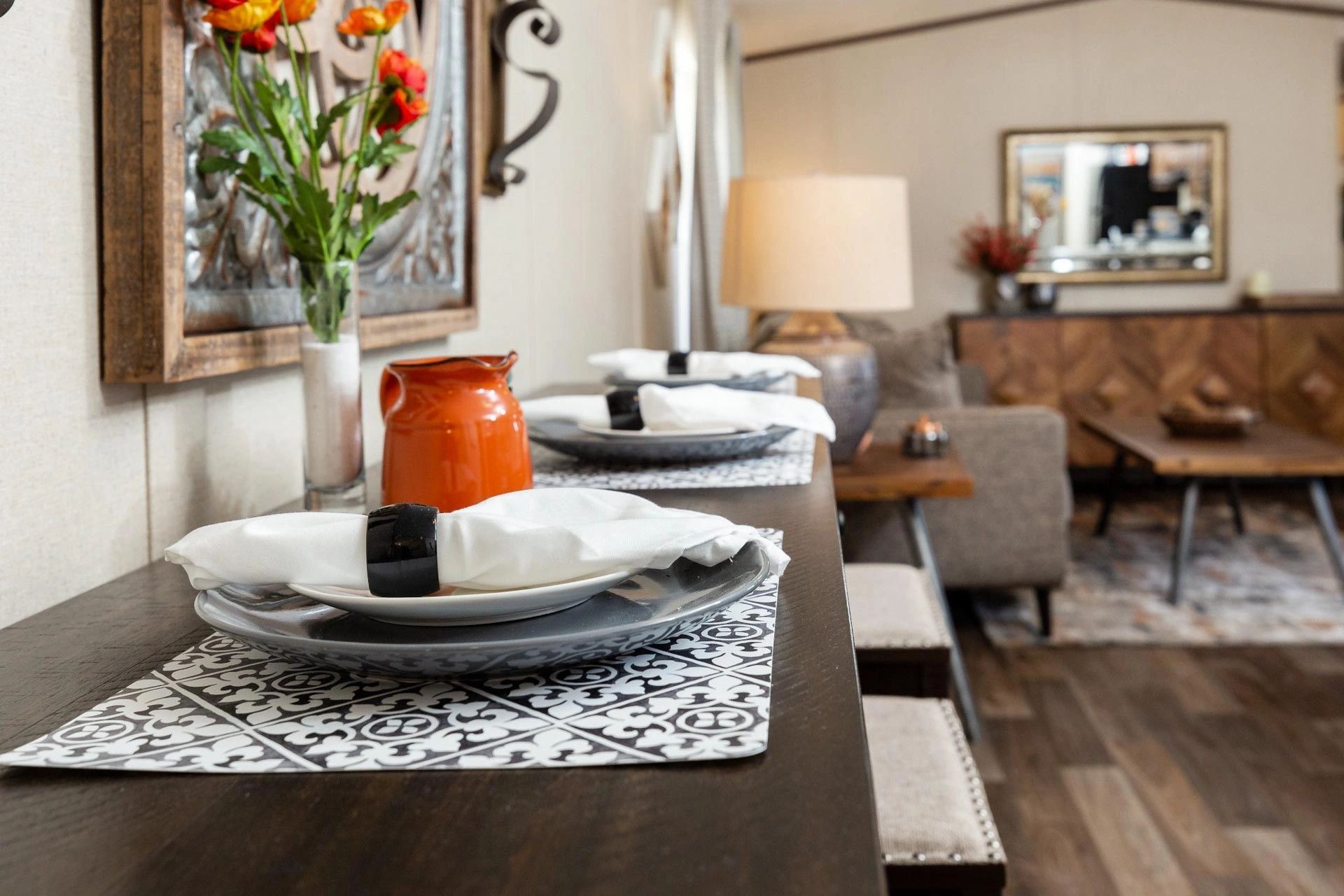 A table with plates and napkins on it in a living room.