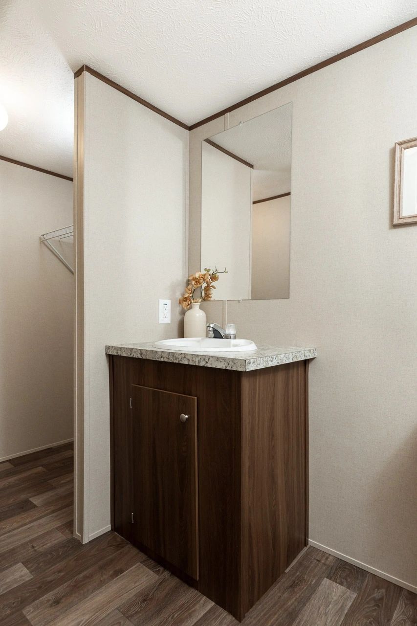 A bathroom with a sink and a mirror.