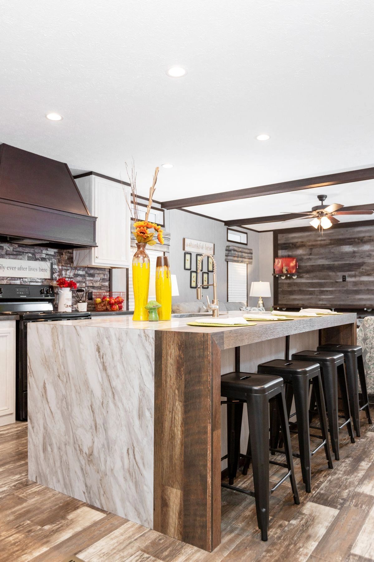 A kitchen with a large island and stools.