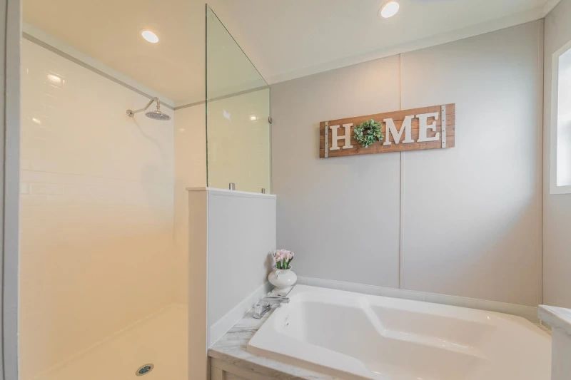 A bathroom with a tub , shower , and sign that says `` home ''.